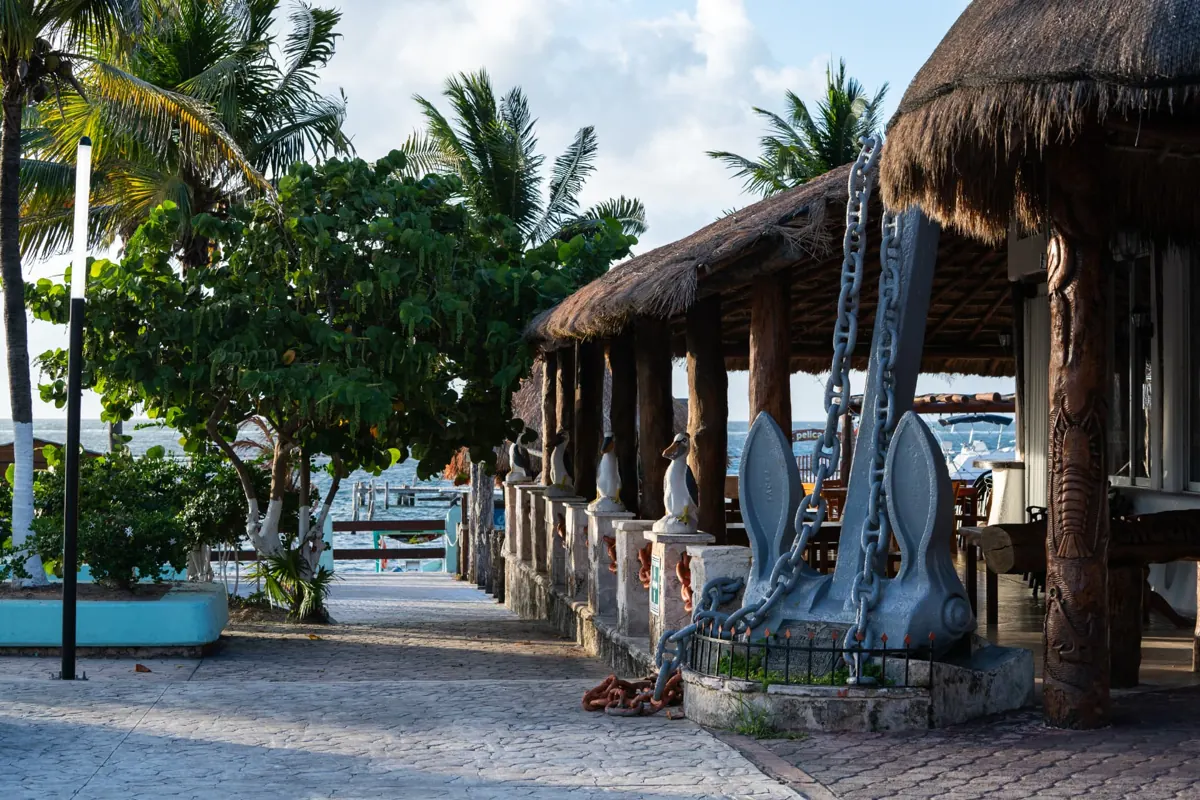 Seaside walkway with palapa restaurants in the town of Puerto Morelos